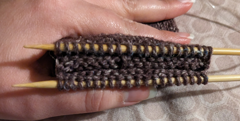 After the waste yarn has been removed, there is a gap in the knitting that can now be knitted as a magic loop.