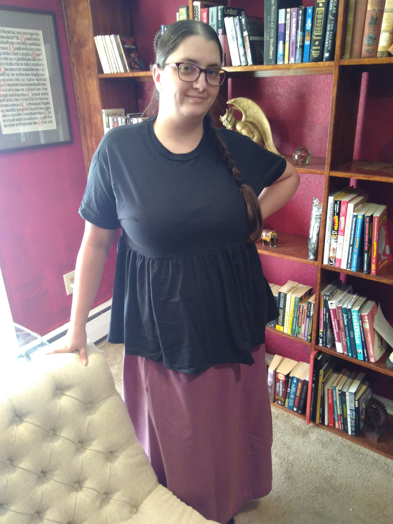 Morgan wearing a black empire waist tee-shirt and a purple skirt