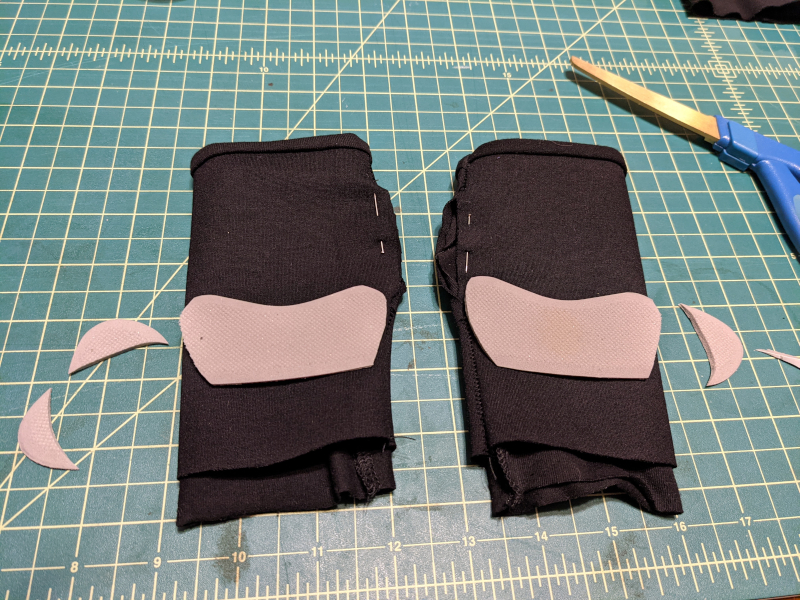 Heel grips cut down to size laid on top of gloves for scale