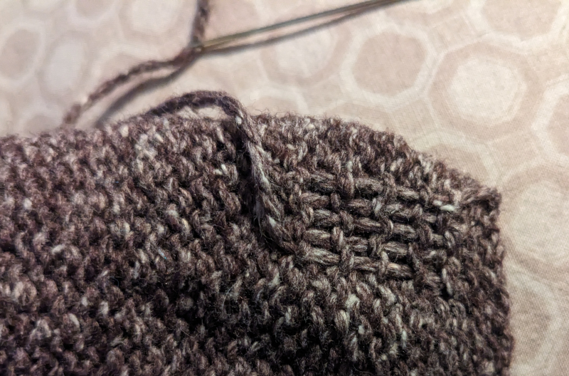 Close up of loose end tied in to sock.